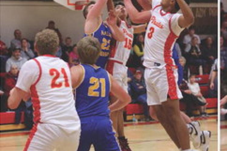 John Fathke and Aziah Meyer fight for the rebound. Photos by Barb Pechous