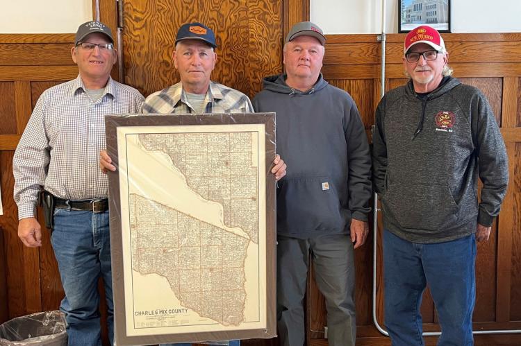 Commissioner Keith Mushitz was presented a framed map of Charles Mix County in recognition of his over two decades of service to the people of Charles Mix County.Pictured, from left: Commissioner Colin Soukup, Commissioner Keith Mushitz, Commissioner-Elec