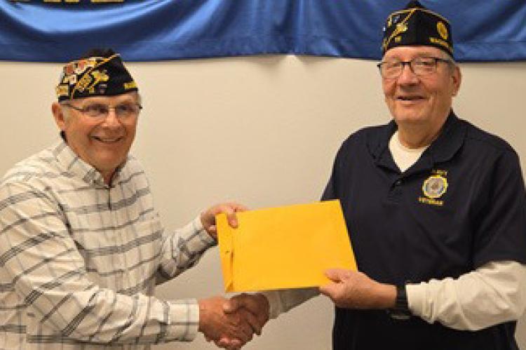 Pictured are Danny Rezac with John Crisman presenting.
