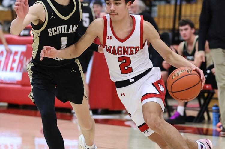 Jesse Zephier drives to the basket for the Red Raiders. Photos by Barb Pechous