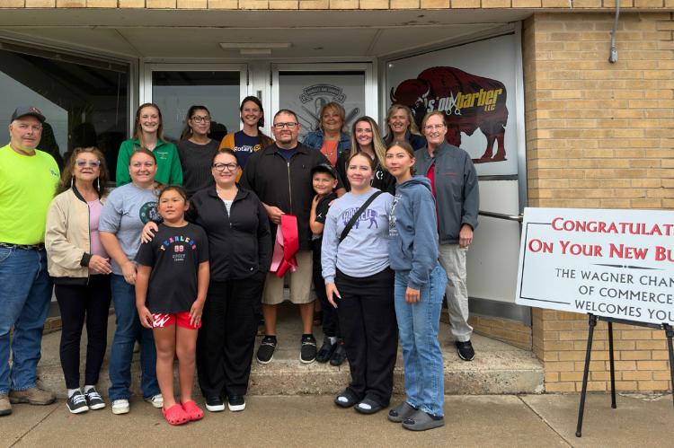 Attending the ribbon-cutting were, back row: Randy Rysavy, Alexa Cimpl, Amelia Spotted Eagle, Margaret Doom, Deb Houseman, Jessa Doom, Michele Juffer, Marla Hewitt; front row: Anne Honomichl, Olivia Cournoyer, Quinn Cournoyer, Chiara Bruguier, Quentin Bru