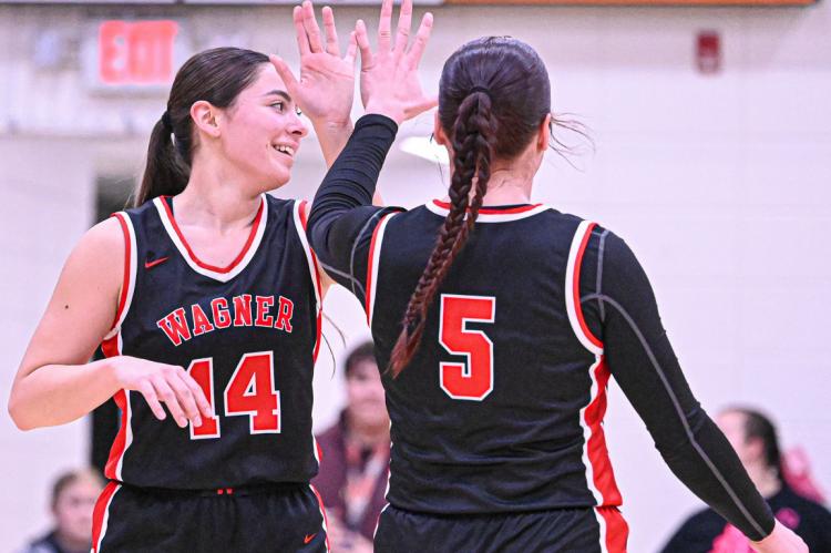 Eve Zephier and Lydia Host high five at Scotland game.