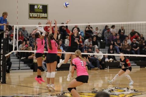 Wagner Lady Raider #16 Ravyn Medricky goes up at the net to make a play against two opposing blockers as her teammates prepare for the next touch. PHOTOGRAPHY BY DENELLE