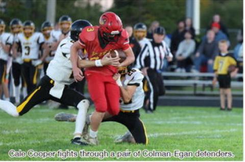 Cale Cooper fights through a pair of Colman-Egan defenders.