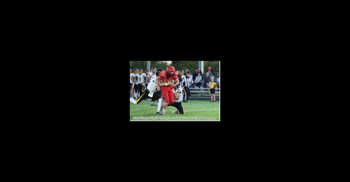 Cale Cooper fights through a pair of Colman-Egan defenders.