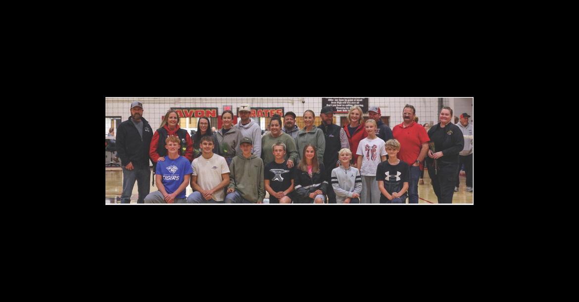 Cross country runners and their parents were recognized at Parents Night during the volleyball match on October 15. XC team members and their parents, pictured from left, are: Jeff and Amy Tolsma, Sarah Mann, Teanna and Dan Kuhlman, Julia and Tyler Sassaman, Samantha and Mark Johnson, Leslie and Branden Baade and Brynn Baade, Aaron and Liz Rush; Front: Cale Cooper, Mason Jolley, Rance Kuhlman, Jacob Sassaman, Sydney Johnson, Rex Baade, and Zane Rush. PHOTO BY BARB PECHOUS