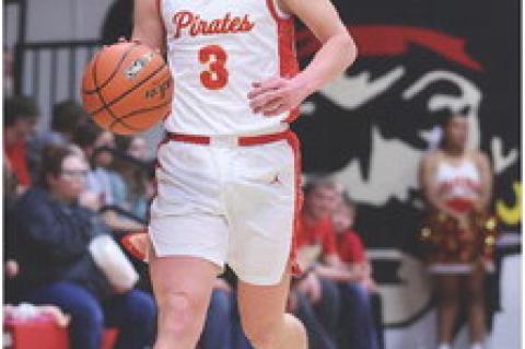 Cale Cooper brings the ball up the court as the Pirates set up their defense.