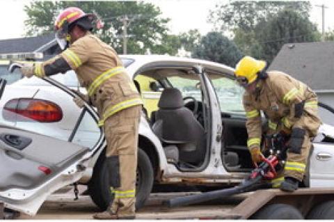 Firefighters Branden Baade and Brady Petrik demonstrate how they cut the doors oa of a car with the Jaws of Life during an accident. Photos by Jenna Petrik.