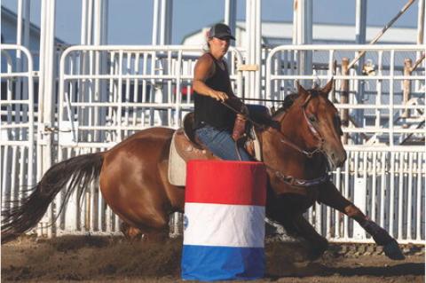 LOCAL RIDERS COMPETE I N BARREL RACING EVENT