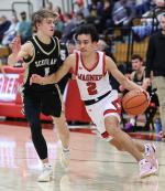 Jesse Zephier drives to the basket for the Red Raiders. Photos by Barb Pechous